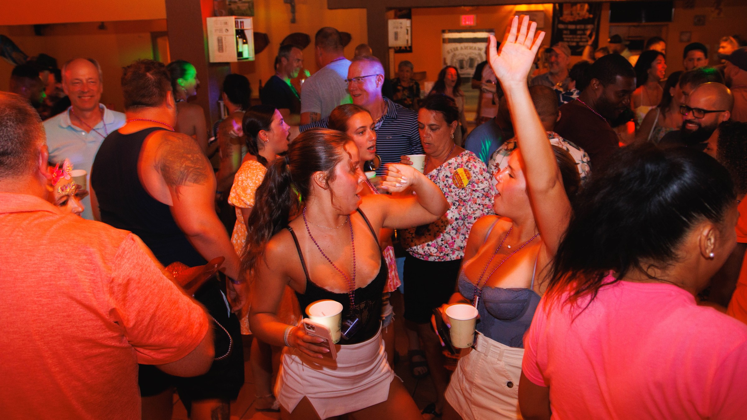 People dancing and socializing at a lively indoor party.