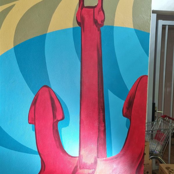 Red anchor on a colorful, abstract background, featuring blue and yellow curves.