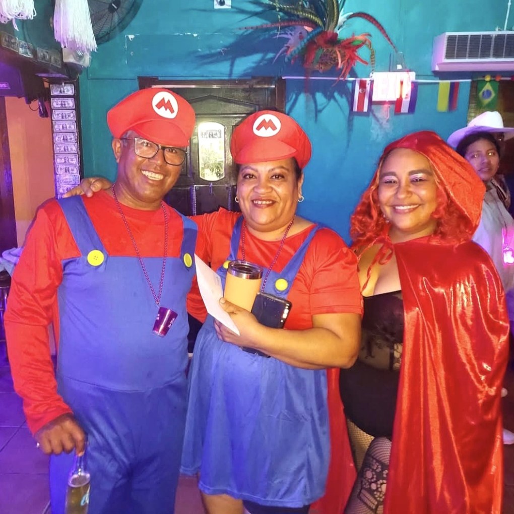 Guests dressed as Mario characters and other Halloween costumes celebrating with Kukoo Kunuku in Aruba.